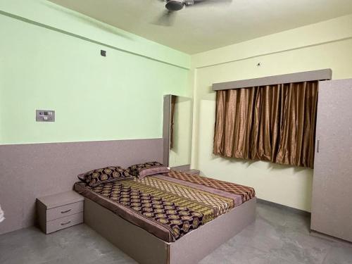 a bedroom with a bed and a window with a curtain at Desai Villa - Pawna Lake in Wadgaon