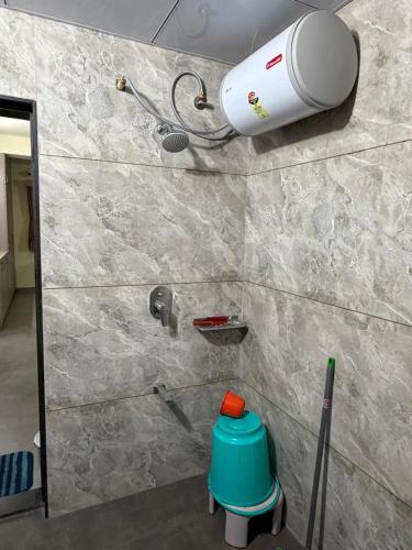 a bathroom with a shower with a blow dryer on the wall at Desai Villa - Pawna Lake in Wadgaon