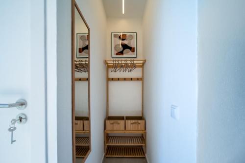 a hallway with a dressing room with a mirror at The Simon Residences - Marina Escape in Olhão