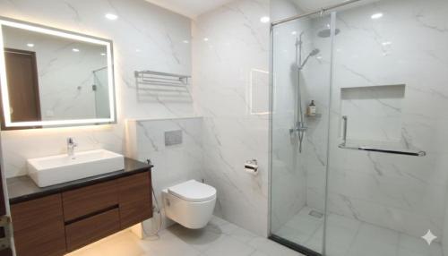 a bathroom with a shower and a toilet and a sink at Hotel The Caves Near IGI Airport Delhi in New Delhi