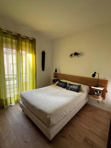 a bedroom with a large bed with yellow curtains at Céret hyper centre - Cozy T2 in Céret