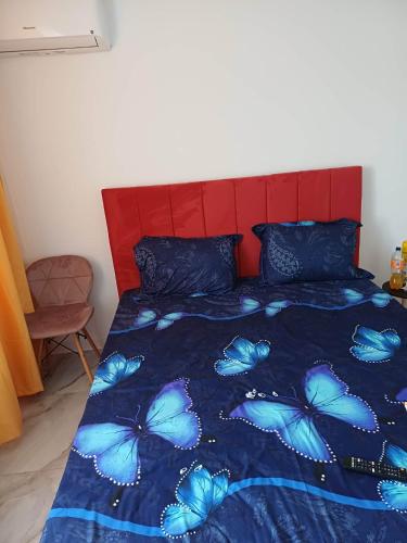 a bedroom with a bed with blue butterflies on it at Ibo in Brăila