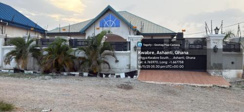 a house with a sign in front of it at Four bedrooms house in Kumasi