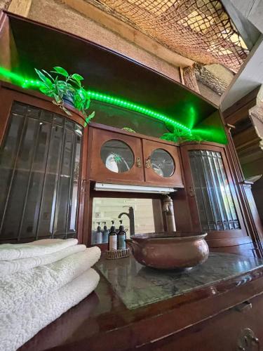 a bathroom with a sink with green lights at EinBaumHaus Wörthersee in Auen