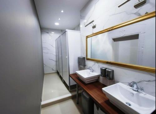 a bathroom with two sinks and a mirror at Boutique Central Square Hostel in Trogir
