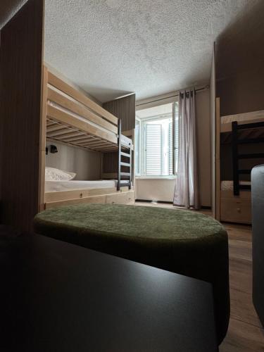 a bedroom with two bunk beds and a window at Boutique Central Square Hostel in Trogir