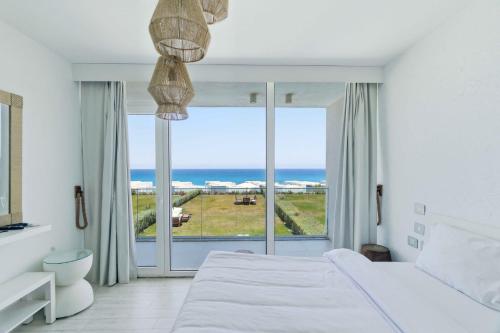 a bedroom with a bed and a view of the ocean at Fouka Bay Holiday Apartments By BlueKeys in Marsa Matruh