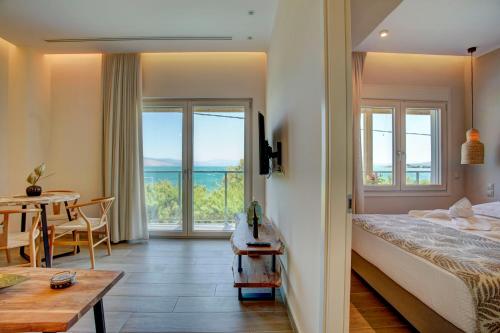 a bedroom with a bed and a table and a dining room at Nyfida's four waves in Nifida