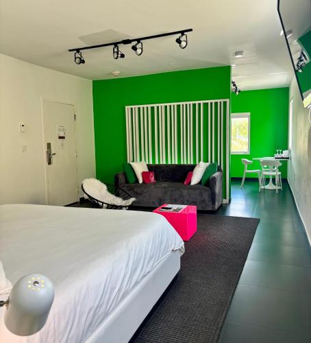 a bedroom with a bed and a green wall at Blanc Kara Boutique Hotel in Miami Beach