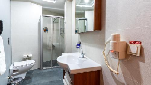 a bathroom with a sink and a shower at Kule Hotel&Spa Gaziantep in Şahinbey