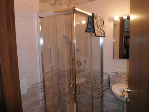 a shower with a glass door in a bathroom at Don Milani in Matera
