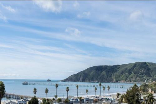 a view of a beach with palm trees and a mountain at Bella Surf in Avila Beach