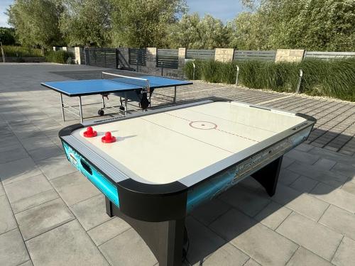 two ping pong tables sitting on top of a patio at Albian Apartamenty in Jantar