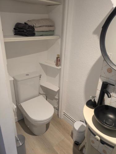 a bathroom with a white toilet and a sink at Passage Foch centre historique in Perpignan