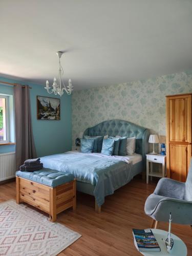 a bedroom with a bed and a couch and a chair at U Helci - Na Krańcu Świata - Azyl tylko dla Dorosłych in Studzienno