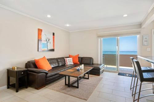 a living room with a leather couch and a table at Carpinteria Shores CS 212 in Carpinteria