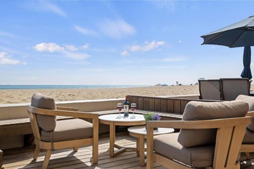 a patio with two chairs and a table on the beach at Carpinteria Shores CS 109 in Carpinteria