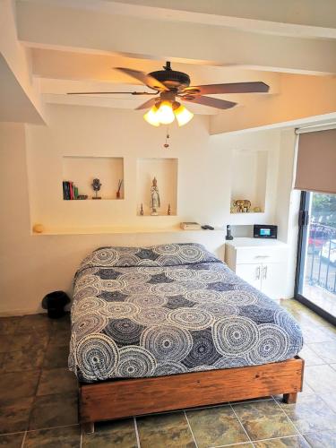 a bedroom with a bed and a ceiling fan at Lake side Luxury Duplex ! in Jurica
