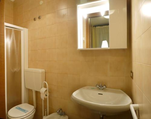 a bathroom with a sink and a toilet and a mirror at Hotel Agli Olmi in San Biagio di Callalta