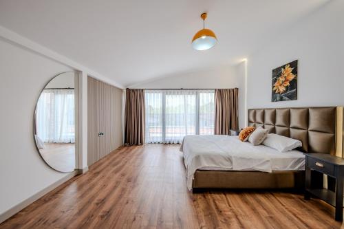 a bedroom with a large bed and a mirror at Luxury Forest Villas with Private Pool in Antalya