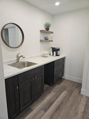 a bathroom with a sink and a mirror at The Hotel on Pownal in Charlottetown
