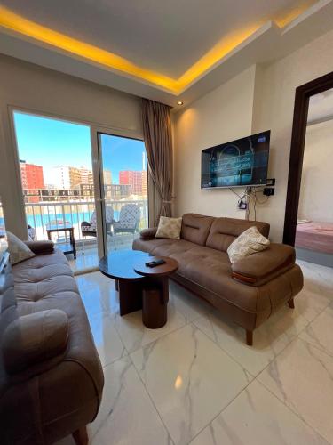 a living room with a couch and a table at عماره 227 in El Alamein