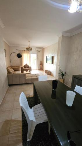a living room with a table and a bed at Villa lux AP2 in Saïdia