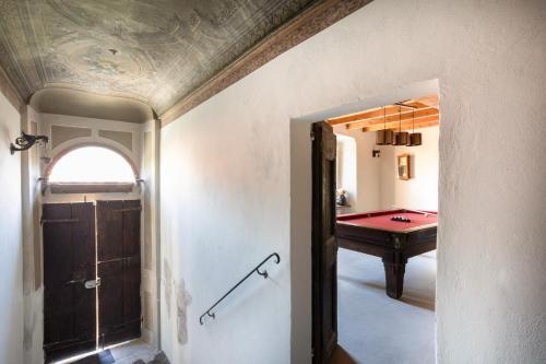 a hallway with a room with a pool table at Antica Villa Branca by Lago Maggiore Rentals in Cannobio