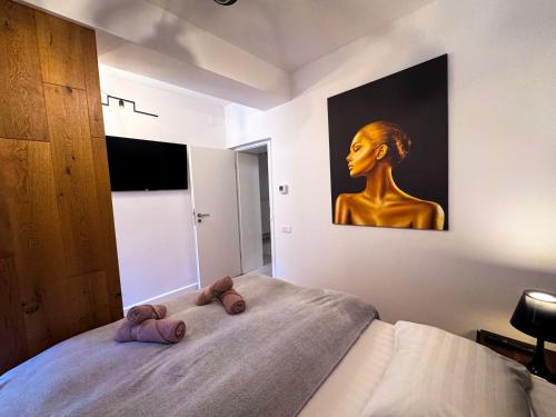 a bedroom with a statue of a woman on a bed at Luxury Apartments C in Braşov
