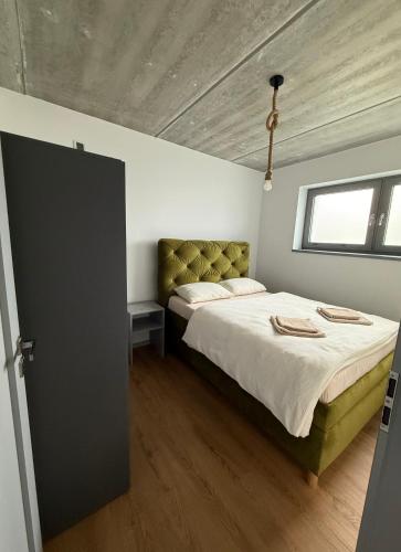 a bedroom with a large bed and a window at Diamond Houses in Námestovo