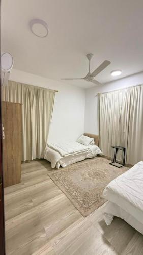 a bedroom with two beds and a ceiling fan at صلالة صحلنوت in Salalah