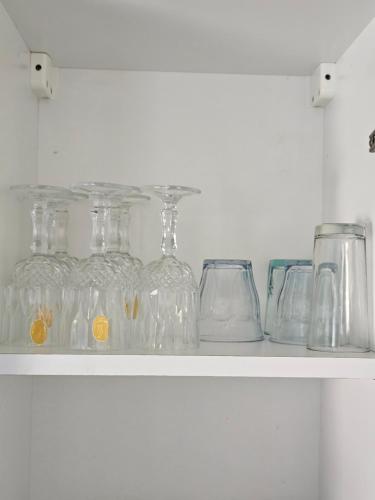 a shelf with glasses and jars on it at Rakkez's house in Hiboun