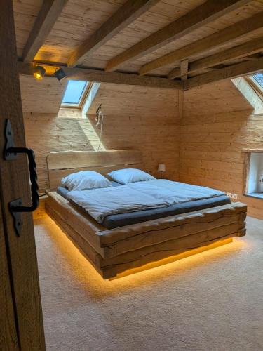 a bedroom with a bed in a wooden room at Gästehaus LeLo 7 in Solingen
