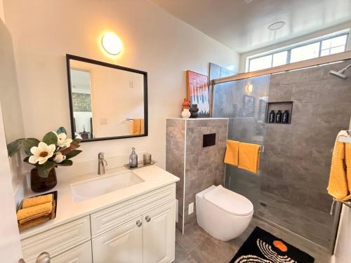 a bathroom with a toilet and a sink and a shower at Charming 3BR Beverly Retreat with Large Private Backyard Bedford in Los Angeles