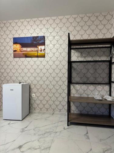 a refrigerator in a room with a picture of a train at Hotel ELYSIUM in Irshava