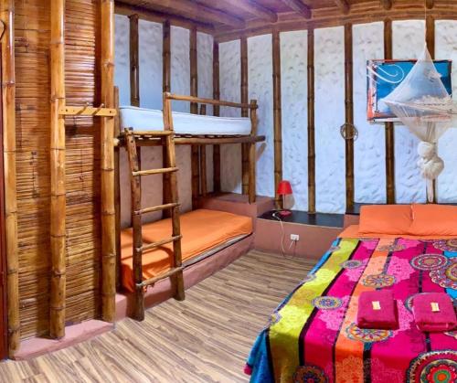 a bedroom with a bunk bed and a ladder at Zaigon Kite Surf in Máncora
