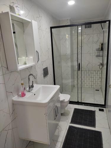 a bathroom with a toilet and a sink and a shower at Garden Prizma Apart in Kemer