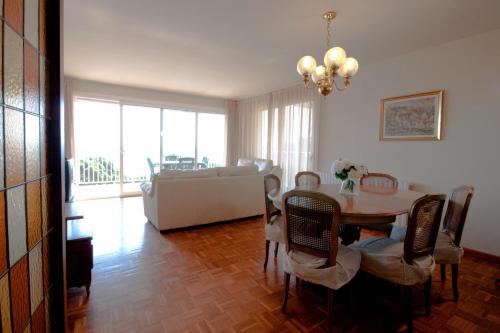 a living room with a table and a couch at Apartamentos Siglo XXI - Marabu in Sant Feliu de Guixols