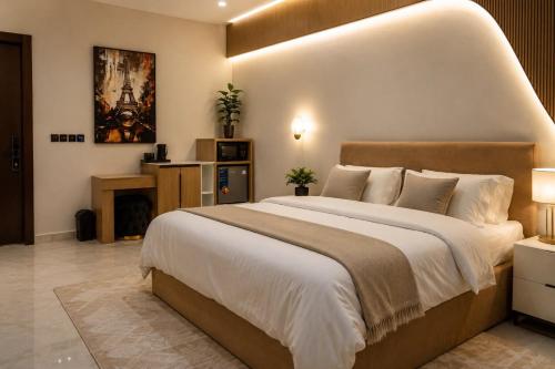 a bedroom with a large bed and a fireplace at CozyKeys luxurious Apartment in Abuja