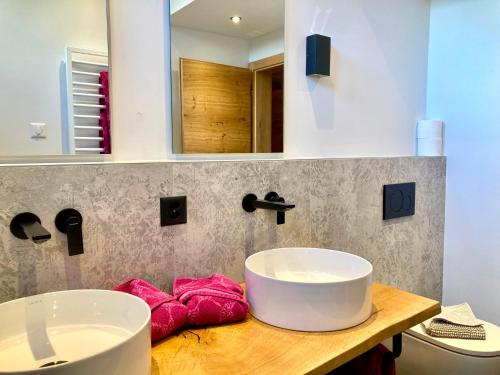 a bathroom with a sink on a wooden counter at Chasa Sot-Chaunt 301 in Samnaun