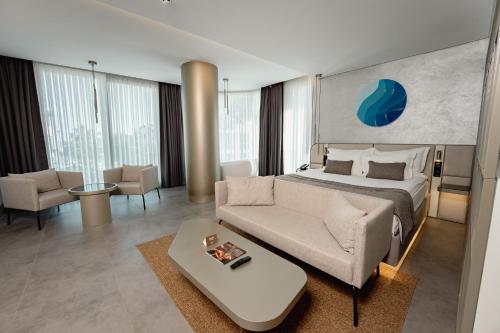 a hotel room with a bed and a couch at Four Hills Hotel in Antalya