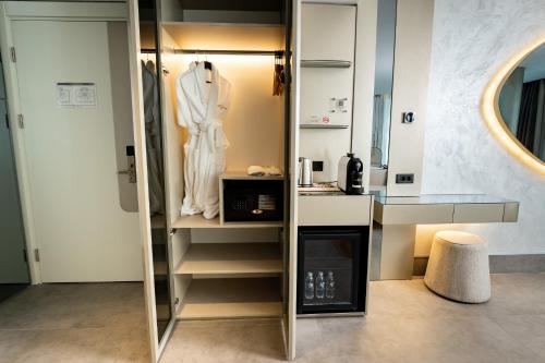 a dressing room with a white robe in a mirror at Four Hills Hotel in Antalya
