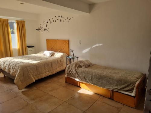 a bedroom with two beds in a room at El Encuentro in Sierra de los Padres