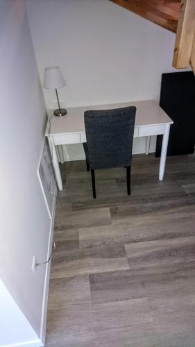 a white desk with a chair and a table and a table and a chair at Chalet Taube in Bad Gastein