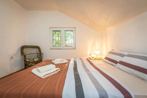 a bedroom with a bed with two towels on it at Villa Stefan Kozuf in Konsko