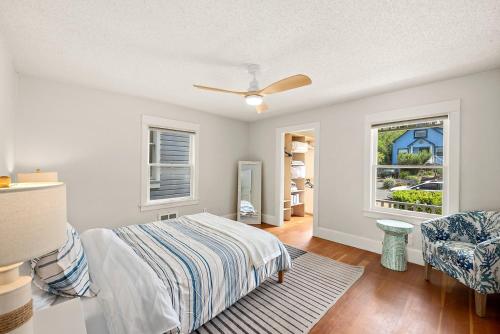 a bedroom with a bed and a chair and a window at Old Tacoma Victorian Main Floor Duplex Unit in Tacoma