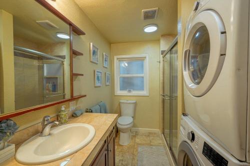a bathroom with a sink and a washing machine at Old Tacoma Victorian Main Floor Duplex Unit in Tacoma