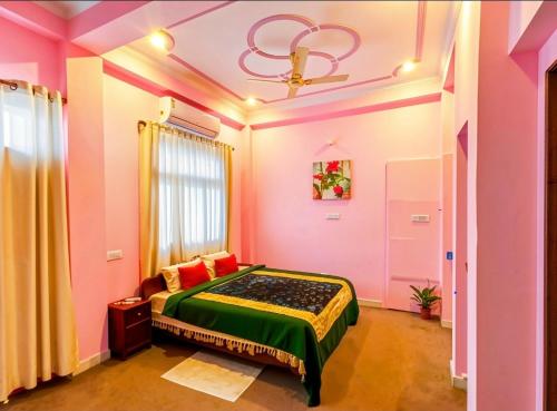a bedroom with a bed in a room with pink walls at Mystic Paradise in Jaipur