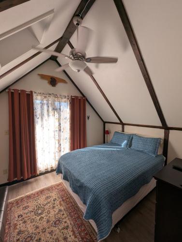 a bedroom with a bed and a ceiling fan at Serene A-frame Cabin Pet Friendly Panoramic View in Sun Valley