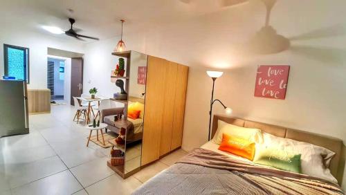 a bedroom with a bed and a room with a table at 38 Romantic Studio Meritus Prai in Perai